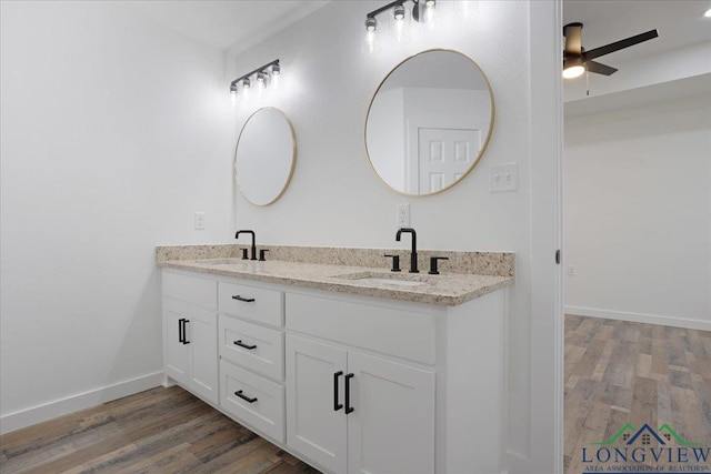 bathroom featuring ceiling fan, vanity, and hardwood / wood-style floors