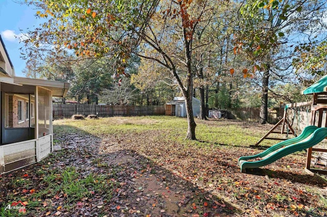 view of yard with a shed and a playground