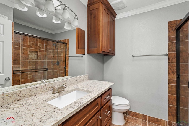 bathroom featuring vanity, tile patterned floors, toilet, ornamental molding, and an enclosed shower