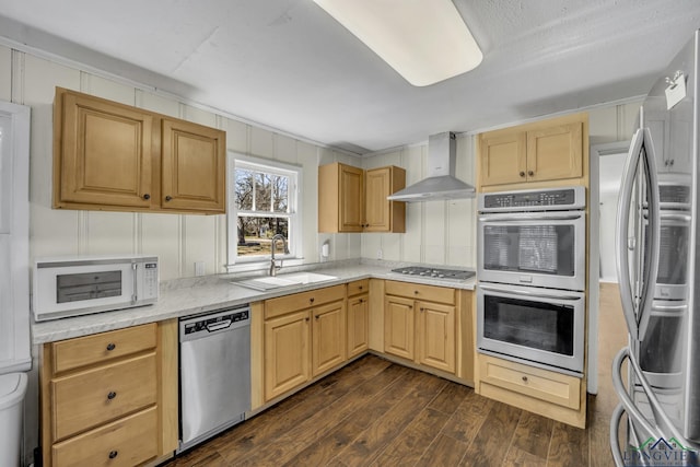 kitchen with sink, light brown cabinets, stainless steel appliances, dark wood-type flooring, and wall chimney range hood