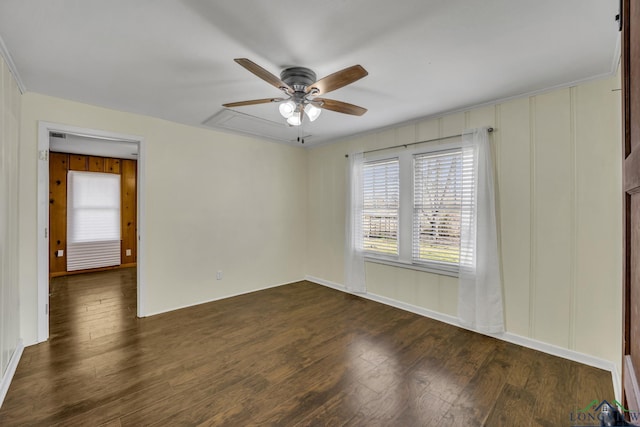 spare room featuring dark hardwood / wood-style flooring and ceiling fan