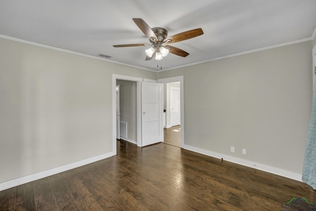 empty room featuring crown molding, dark hardwood / wood-style floors, and ceiling fan