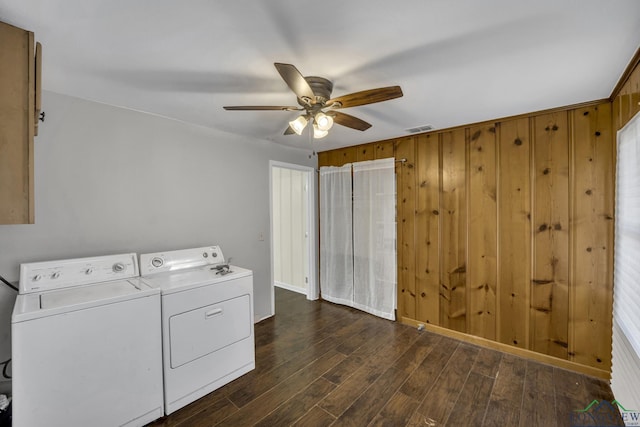 washroom featuring dark hardwood / wood-style flooring, wooden walls, independent washer and dryer, and ceiling fan