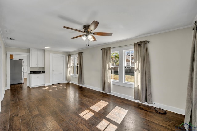 unfurnished living room featuring crown molding, dark wood-type flooring, and ceiling fan