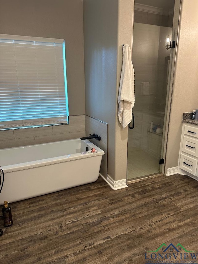 bathroom featuring hardwood / wood-style flooring, vanity, separate shower and tub, and crown molding