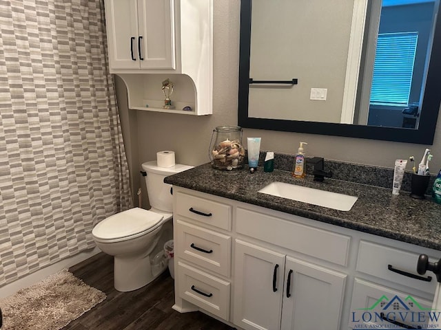 bathroom with vanity, hardwood / wood-style flooring, and toilet