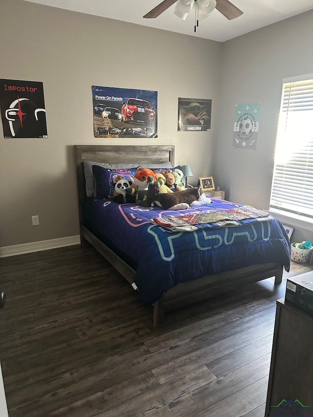 bedroom with dark hardwood / wood-style flooring and ceiling fan