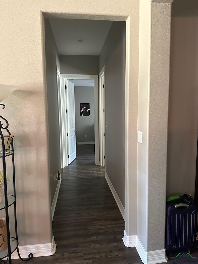 corridor featuring dark hardwood / wood-style floors