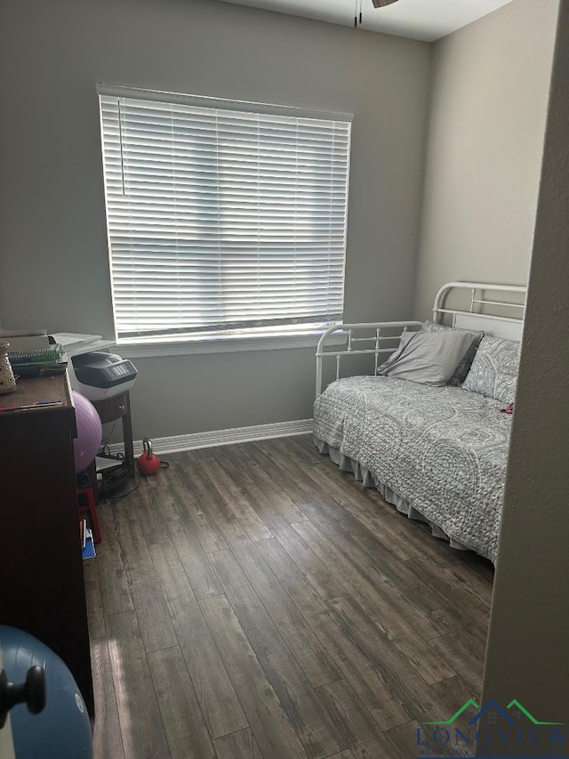 bedroom with dark hardwood / wood-style floors