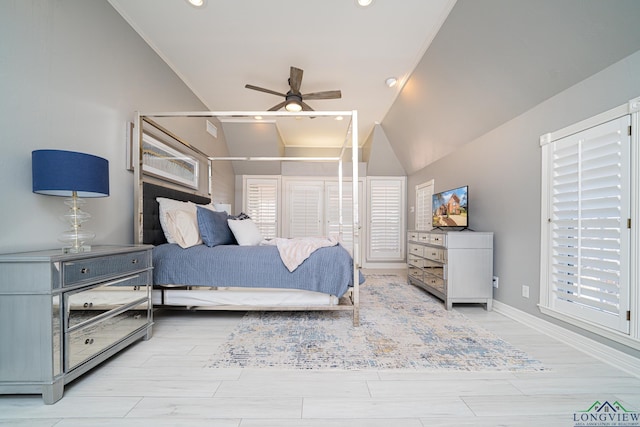 bedroom with ceiling fan, baseboards, lofted ceiling, and light wood-style flooring