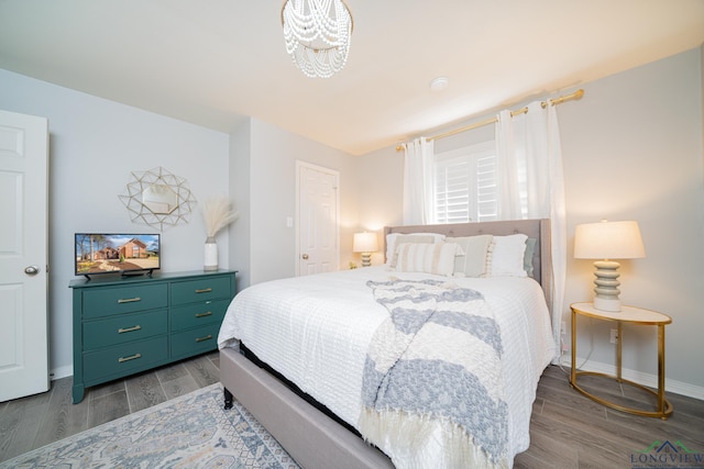 bedroom with baseboards and wood tiled floor