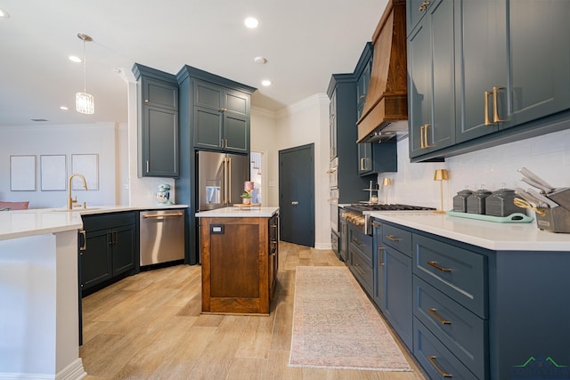 kitchen with decorative backsplash, crown molding, appliances with stainless steel finishes, and a sink