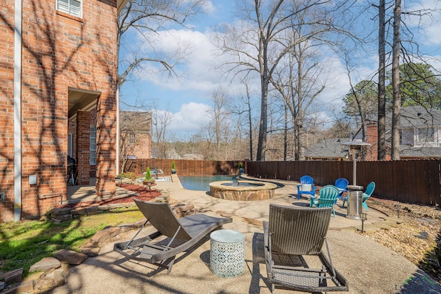 view of patio / terrace with a fenced in pool, an in ground hot tub, and a fenced backyard