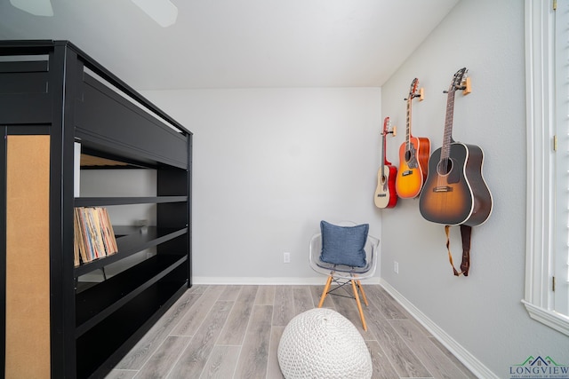 sitting room featuring light wood-style flooring and baseboards