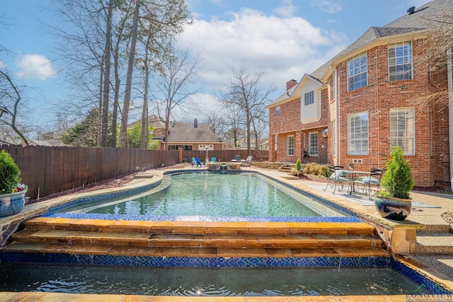 view of swimming pool with a fenced in pool, a fenced backyard, and a patio area