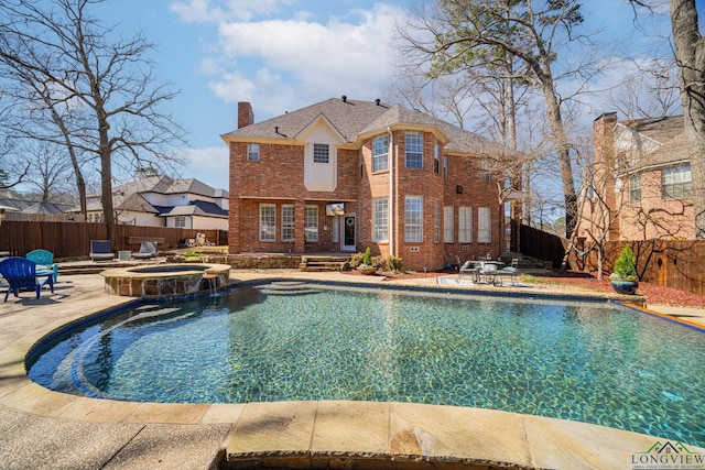 view of swimming pool featuring a patio, a pool with connected hot tub, and a fenced backyard