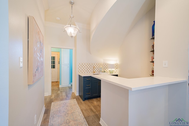 corridor featuring light wood-style floors and baseboards