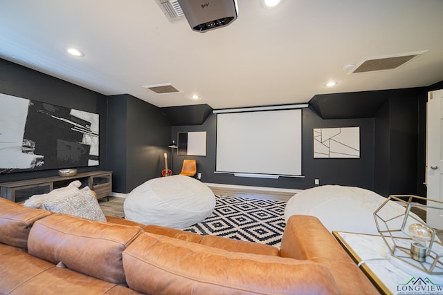 home theater room featuring recessed lighting, visible vents, and wood finished floors