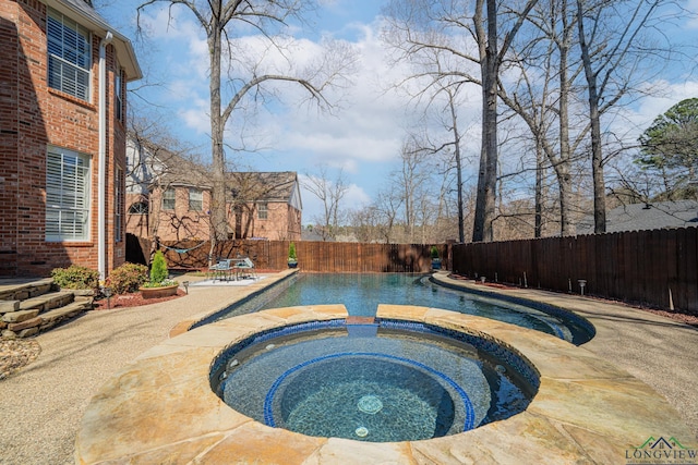 view of pool with a patio area, a fenced in pool, an in ground hot tub, and a fenced backyard