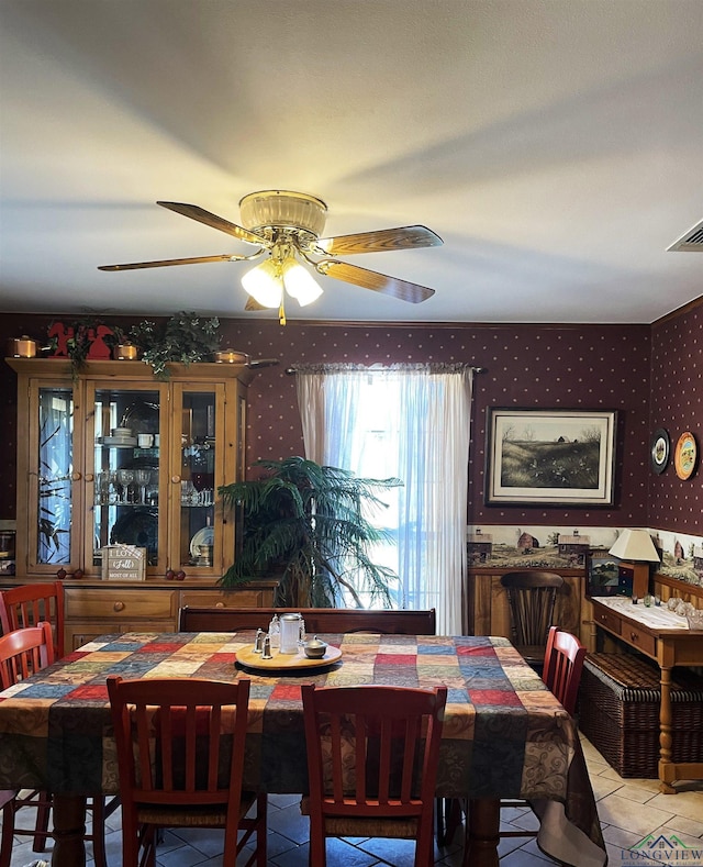 tiled dining space featuring ceiling fan