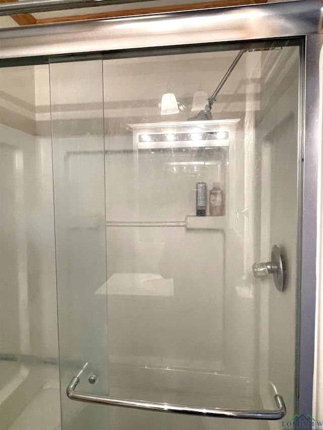 bathroom featuring shower / bath combination with glass door