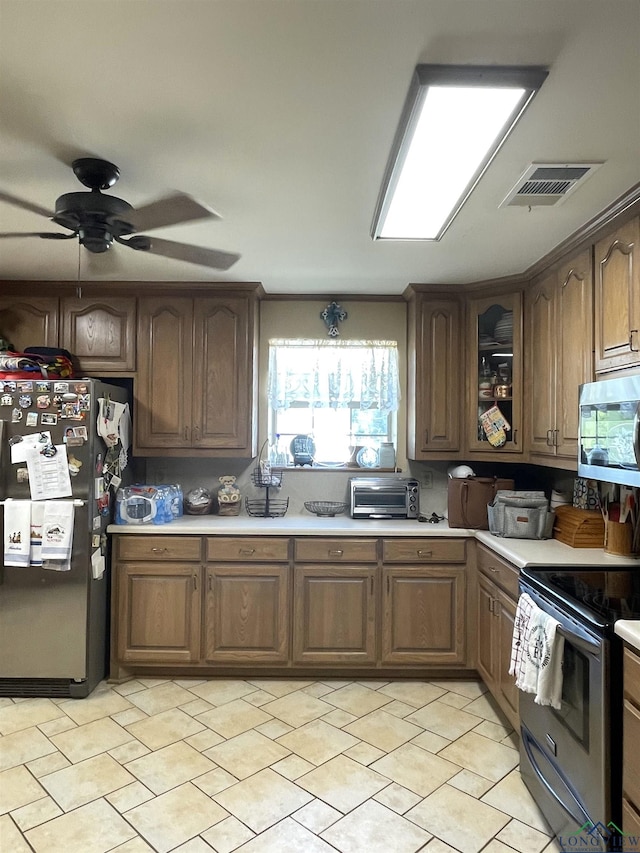 kitchen with ceiling fan and appliances with stainless steel finishes