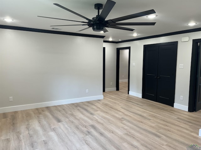 unfurnished bedroom with light wood finished floors, visible vents, ornamental molding, and baseboards