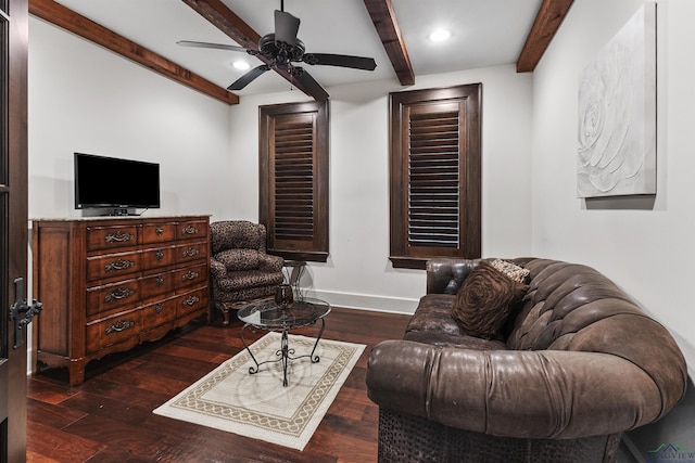 living room featuring beamed ceiling, ceiling fan, and dark wood-type flooring