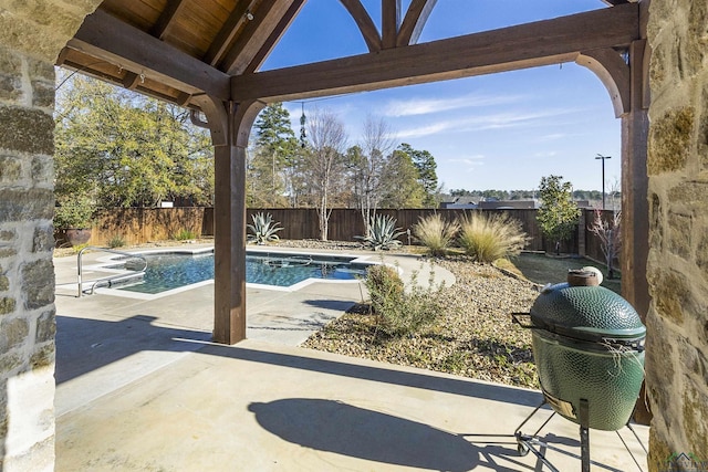 view of patio featuring a fenced in pool and grilling area