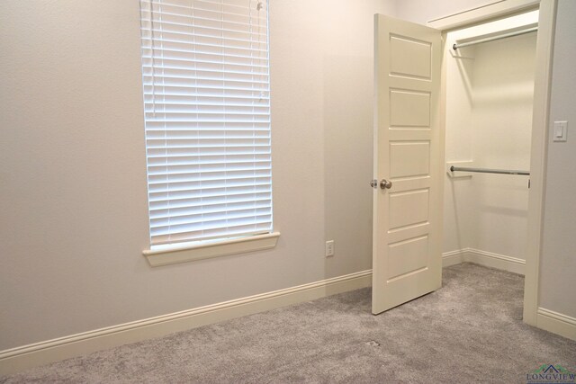 9173 Cave Branch Cv, Tyler, TX 75703 - unfurnished bedroom with baseboards, a closet, and carpet flooring