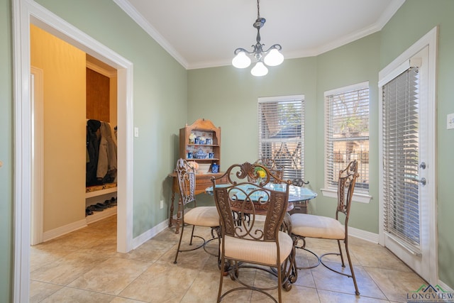 dining room with a chandelier, light tile patterned flooring, crown molding, and baseboards