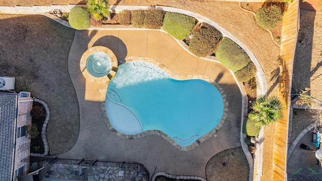 view of swimming pool with an in ground hot tub