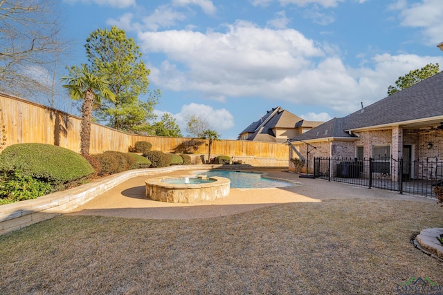 view of yard with a pool with connected hot tub, a fenced backyard, and a patio