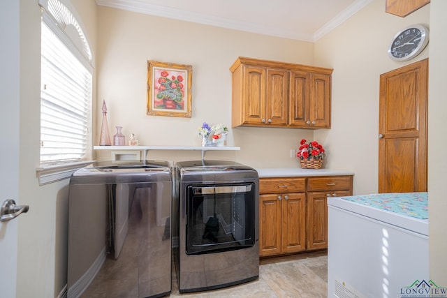 laundry area featuring ornamental molding, washer and dryer, and cabinet space