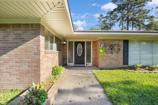 property entrance with brick siding