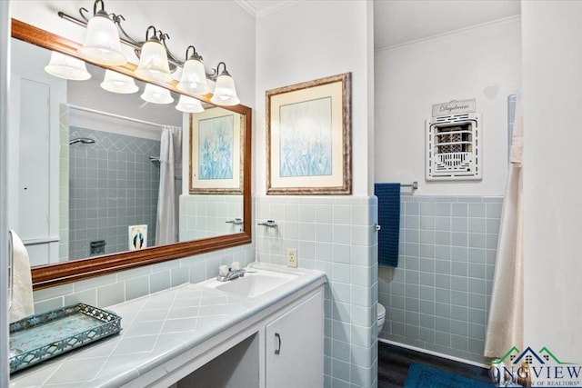 full bath featuring crown molding, tile walls, vanity, toilet, and curtained shower