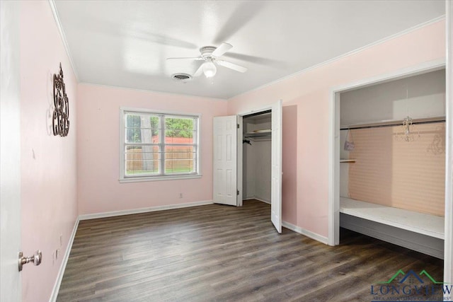 unfurnished bedroom with dark wood-style flooring, baseboards, crown molding, and ceiling fan