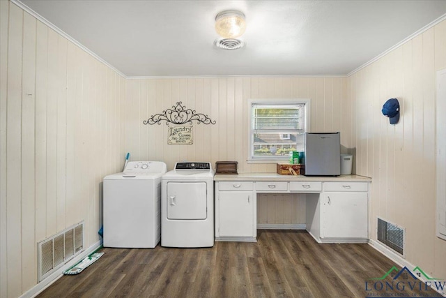 laundry area featuring independent washer and dryer, dark wood-style floors, an office area, crown molding, and cabinet space