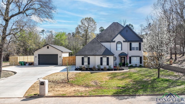 view of front of property with a front yard, a garage, and an outdoor structure