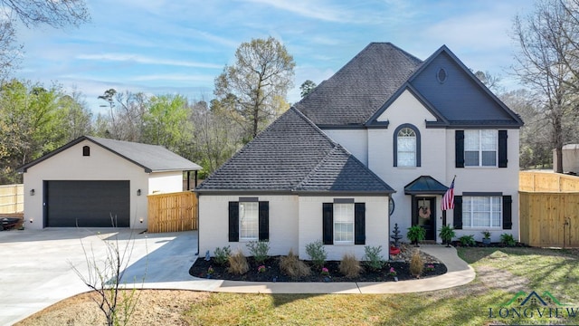 view of front of property with a garage and an outbuilding