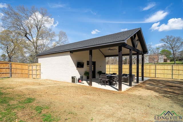 back of property with ceiling fan and a patio