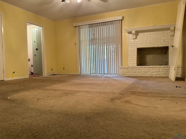 unfurnished living room featuring a brick fireplace, carpet floors, and a textured ceiling