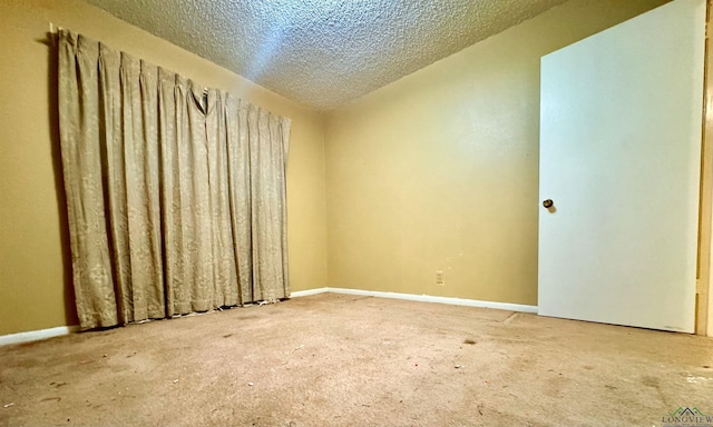 unfurnished room featuring a textured ceiling