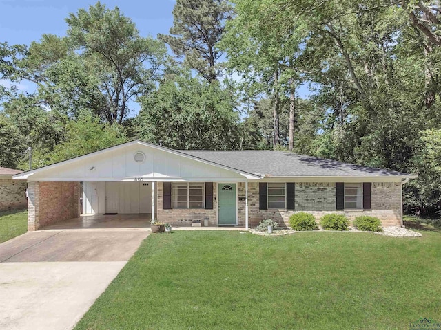 ranch-style home with brick siding, driveway, a front lawn, and an attached carport