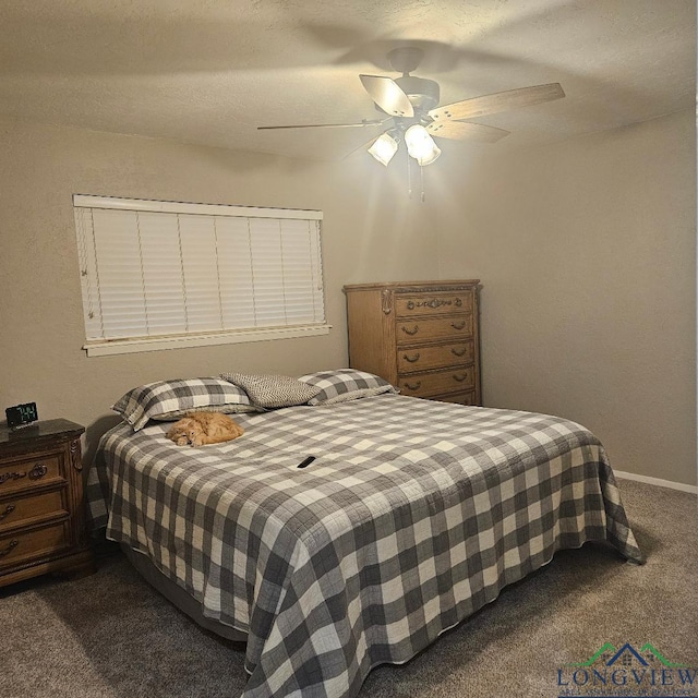 carpeted bedroom with ceiling fan and a textured ceiling