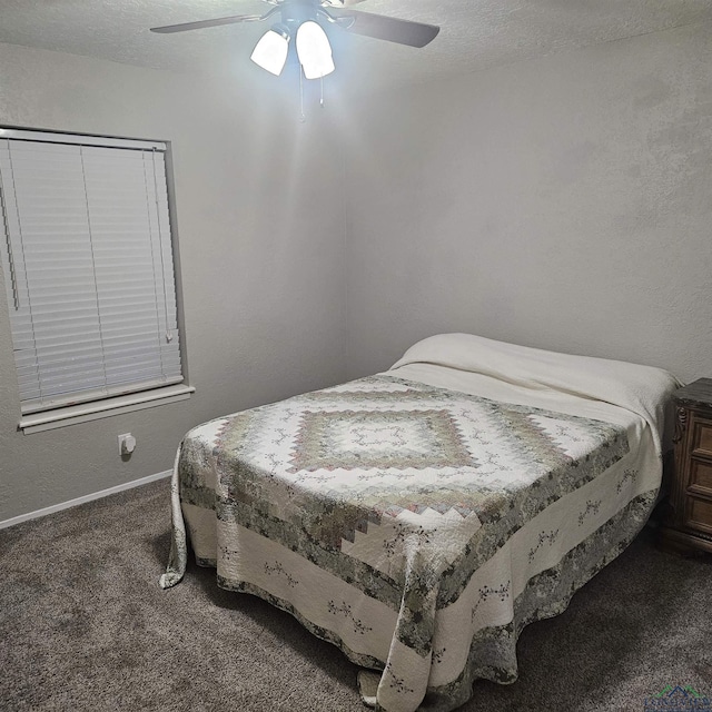 carpeted bedroom with a textured ceiling and ceiling fan