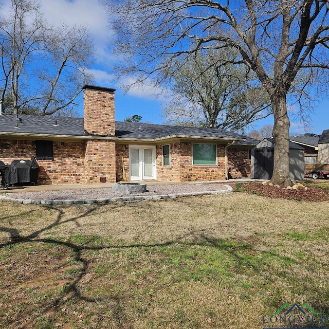 back of property with a patio and a yard