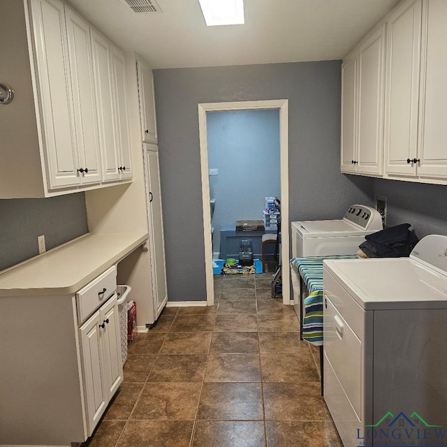 washroom featuring cabinets and independent washer and dryer