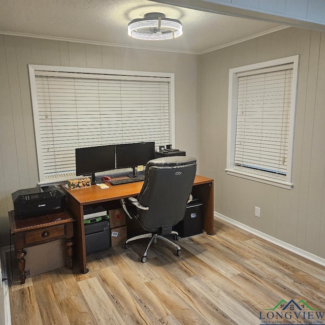 office area with ornamental molding and light wood-type flooring