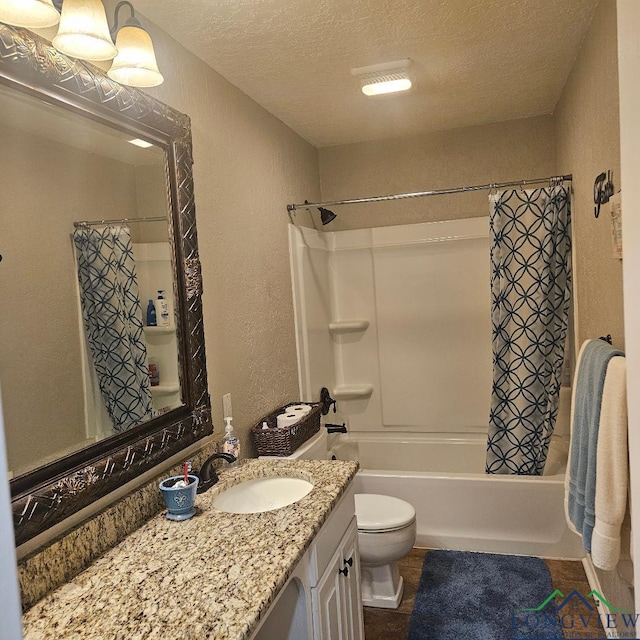 full bathroom with vanity, shower / tub combo, a textured ceiling, and toilet